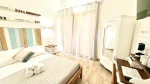 a bedroom with a bed with two towels on it at Il Soffione in Castelsardo