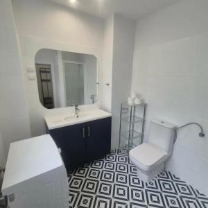 a bathroom with a toilet and a sink and a mirror at Willa Na Deptaku in Pobierowo +13 photos