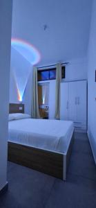 a bedroom with a bed with a blue light at Apartamento Duplex Boa Vista in Sal Rei