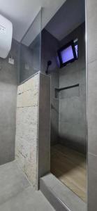 a bathroom with a shower with a window in it at Apartamento Duplex Boa Vista in Sal Rei +16 photos