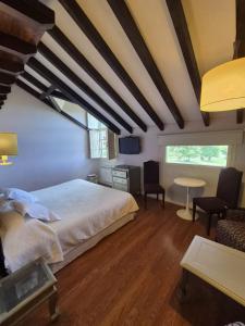 a bedroom with a bed and a table and chairs at Posada torre del milano in Comillas +37 photos