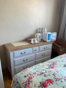 a dresser with a microwave on top of it at Private double room at Caroline's Guest House, River Street, Clara in Tara