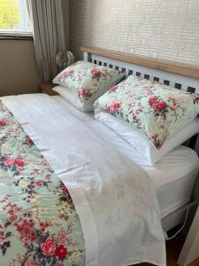 a bed with two pillows on top of it at Private double room at Caroline's Guest House, River Street, Clara in Tara