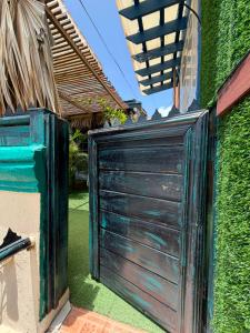 a wooden garage door on the side of a house at Valle Romantico in Manoguayabo