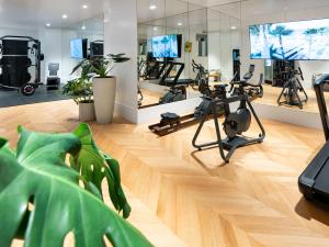 a gym with bikes and exercise equipment in a room at THE DOLLI at Acropolis, A Hotel to Live in Athens