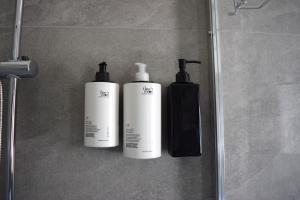 two bottles ofodorizers on a wall in a bathroom at Pierre Palace in Isola Sacra +13 photos