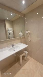 a bathroom with a sink and a mirror and a toilet at Residence Club Inn in Nice