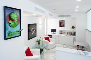 a living room with a green painting on the wall at La Ciliegina Lifestyle Hotel in Naples