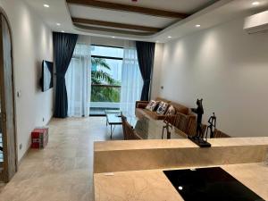 a living room with a couch and a table at Aviera Boutique in Liên Trì (4)