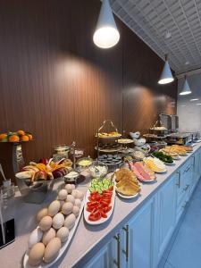 a buffet line with many plates of food and eggs at Marmaris Rakat Hotel in Yakkasaray
