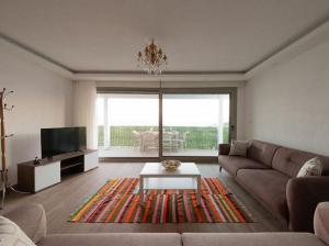 a living room with a couch and a coffee table at BODRUM BURCU RESIDENCE, Magnificent Sea View, Cozy, Free Otopark, Free Wifi in Bodrum City