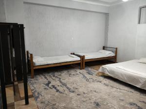 a room with two beds and a wall at SALEM hotel in Türkistan