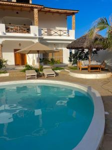 a large swimming pool in front of a house at Ocean view in Watamu