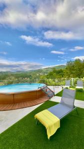 a large swimming pool with a yellow bench on the grass at Refúgio do Espigueiro in Amarante