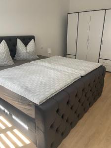 a large bed in a bedroom with a bed frame at Ferienwohnung Jach in Triglitz