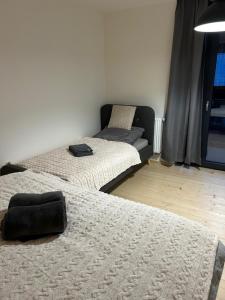 a room with three beds and a window at Harrachovský Chalet Gryf u sjezdovky in Ryžoviště