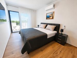 a bedroom with a large bed and a balcony at Villa Dijana with Pool - Sol Tours in Kras +14 photos