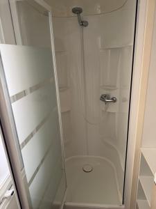 a glass shower with a toilet in a bathroom at Chez Axel in Pradons +13 photos