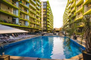 a swimming pool in front of some apartment buildings at Alezi Apartamente in Mamaia Sat/Năvodari