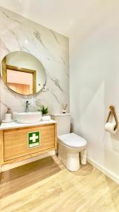 a bathroom with a sink and a toilet and a mirror at Refúgio do Espigueiro in Amarante +15 photos