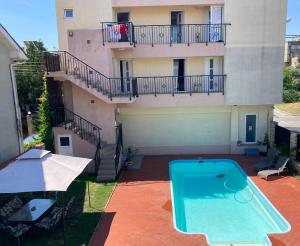 an apartment with a swimming pool in front of a building at Beach House in Mamaia Sat/Năvodari