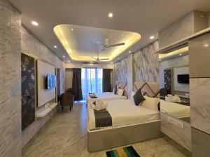 a hotel room with two beds and a ceiling at Parth King Resort Tarapith A Unit of Prattay Infratech Private Limited in Tarapith +110 photos