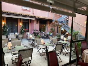 a restaurant with tables and chairs on a patio at Hostellerie du Forez in Saint-Galmier