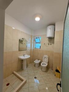 a bathroom with a toilet and a sink at Alexa Beach Apartment in Velipojë +31 photos