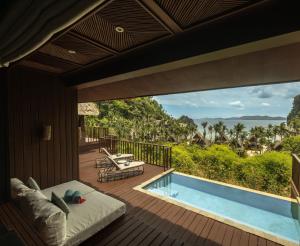 a room with a bed and a pool on a deck at Cauayan Boutique Private Island - formerly Cauayan Island Resort in El Nido