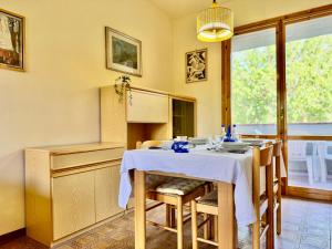 a dining room with a white table and chairs at Villetta Mascagni in Lido Adriano