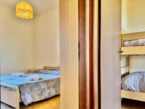 a bedroom with a bed and a bunk bed at Villetta Mascagni in Lido Adriano