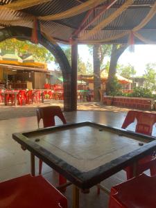 a table and chairs in a patio with tables and chairs at Horseland Hotel & Mountain Spa in Matheran