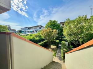 a view of a garden with a fence and a house at Villetta Mascagni in Lido Adriano