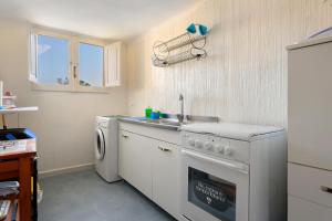 a kitchen with a sink and a washing machine at Villa Ondina 1 Carloforte in Carloforte +24 photos
