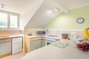 a kitchen with a stove and a clock on the wall at 1 Bed in Raithby oc-h42745 in Raithby