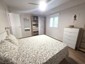a bedroom with a bed and a dresser in it at Martita Home in Zaragoza +2 photos