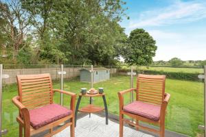 two chairs and a table on a patio at 1 Bed in Raithby oc-h42745 in Raithby