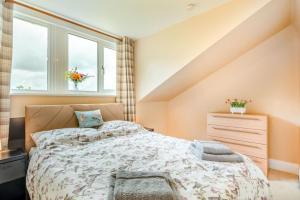 a bedroom with a bed and two windows at 1 Bed in Raithby oc-h42745 in Raithby