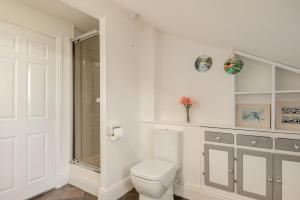 a white bathroom with a toilet and a window at 1 Bed in Raithby oc-h42745 in Raithby +10 photos
