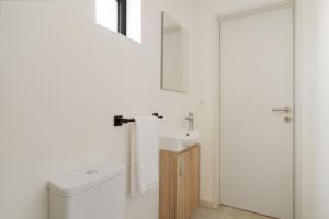 a white bathroom with a sink and a toilet at Casa Pitoresca - Refugio Esposende in Braga +29 photos