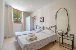 a bedroom with a bed with a mirror on it at Casa Nord in El Port de la Selva