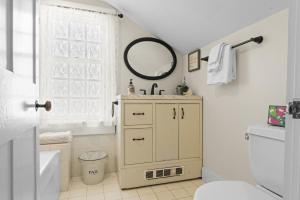 a bathroom with a sink and a mirror at Historic Waterfront Home and Cottage in Groton +84 photos
