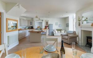 a kitchen and living room with a table and chairs at 5 Old School Mews Shanklin in Shanklin