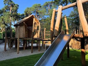 a playground with a slide and a play structure at Van der Valk Hotel Harderwijk op de Veluwe in Harderwijk