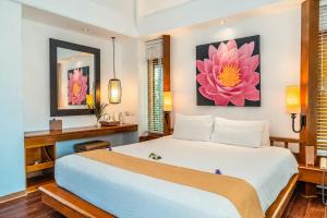 a bedroom with a large white bed and a desk at Centara Villas Samui in Lamai