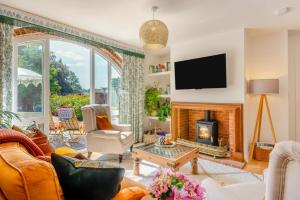 a living room with a fireplace and a tv at 2 Bed in Great Witchingham oc-p45227 in Reepham