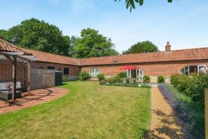 an exterior view of a brick house with a yard at 2 Bed in Great Witchingham oc-p45227 in Reepham