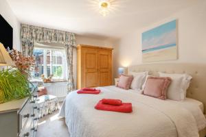 a bedroom with a large bed with red towels on it at 2 Bed in Great Witchingham oc-p45227 in Reepham +46 photos