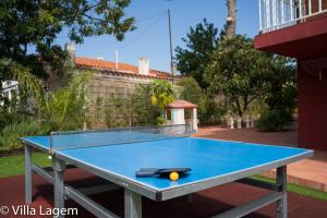 a blue ping pong table with a ball on it at VILLA LAGEM, Casa con piscina, barbacoa, jardín in Cubelles
