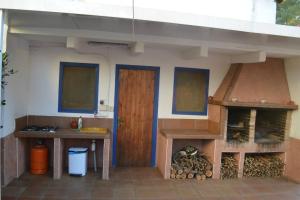 an outdoor kitchen with a wood stove and an oven at VILLA LAGEM, Casa con piscina, barbacoa, jardín in Cubelles
